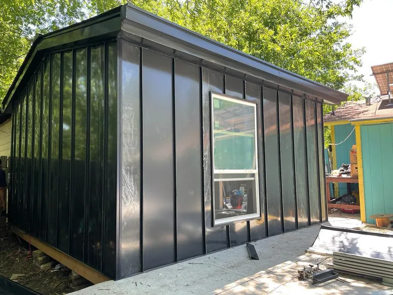 Black standing seam metal wall panels for Roof Inspection in Choctaw