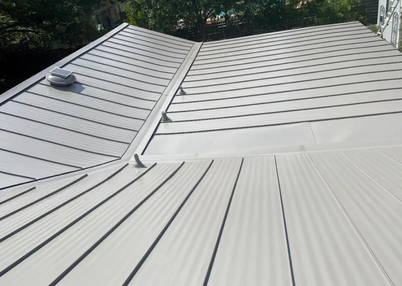 Solar attic fan installed on a metal roof for Roof Ventilation in Choctaw